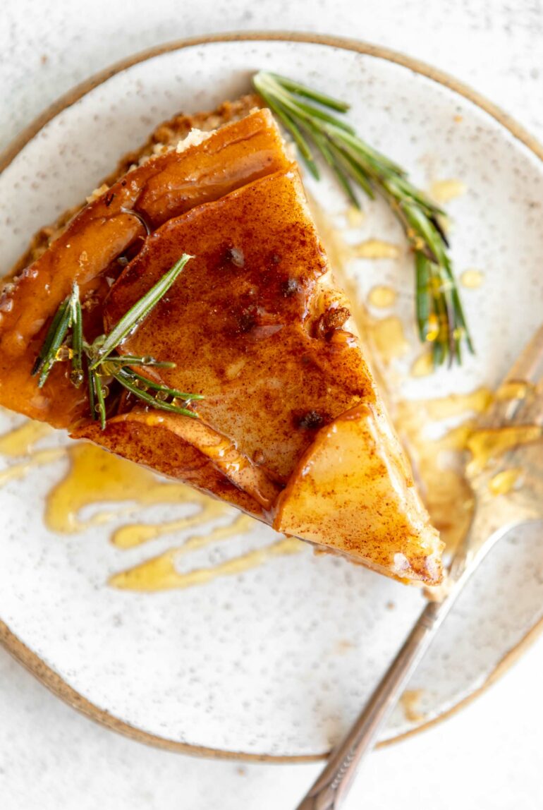Slice of Honey Pear Ginger Cheesecake on a plate.