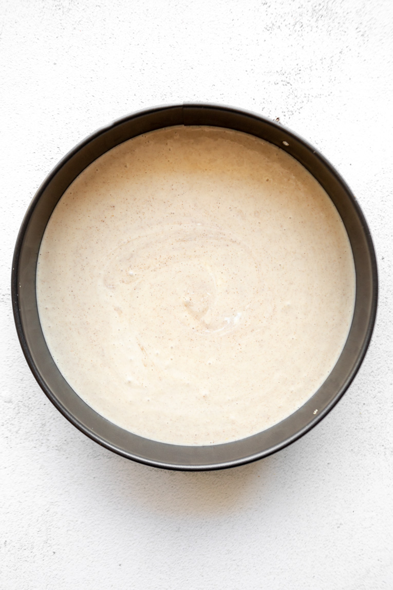 Cheesecake filling poured into a springform pan.