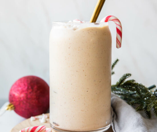 Peppermint Frosty Recipe in a glass with candy canes.
