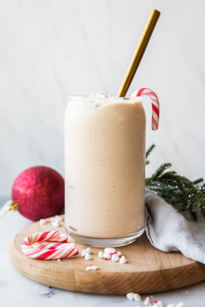 Peppermint Frosty Recipe in a glass with candy canes.