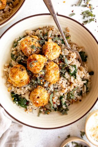 Turkey Sage Meatballs in a dutch oven with parmesan kale orzo.