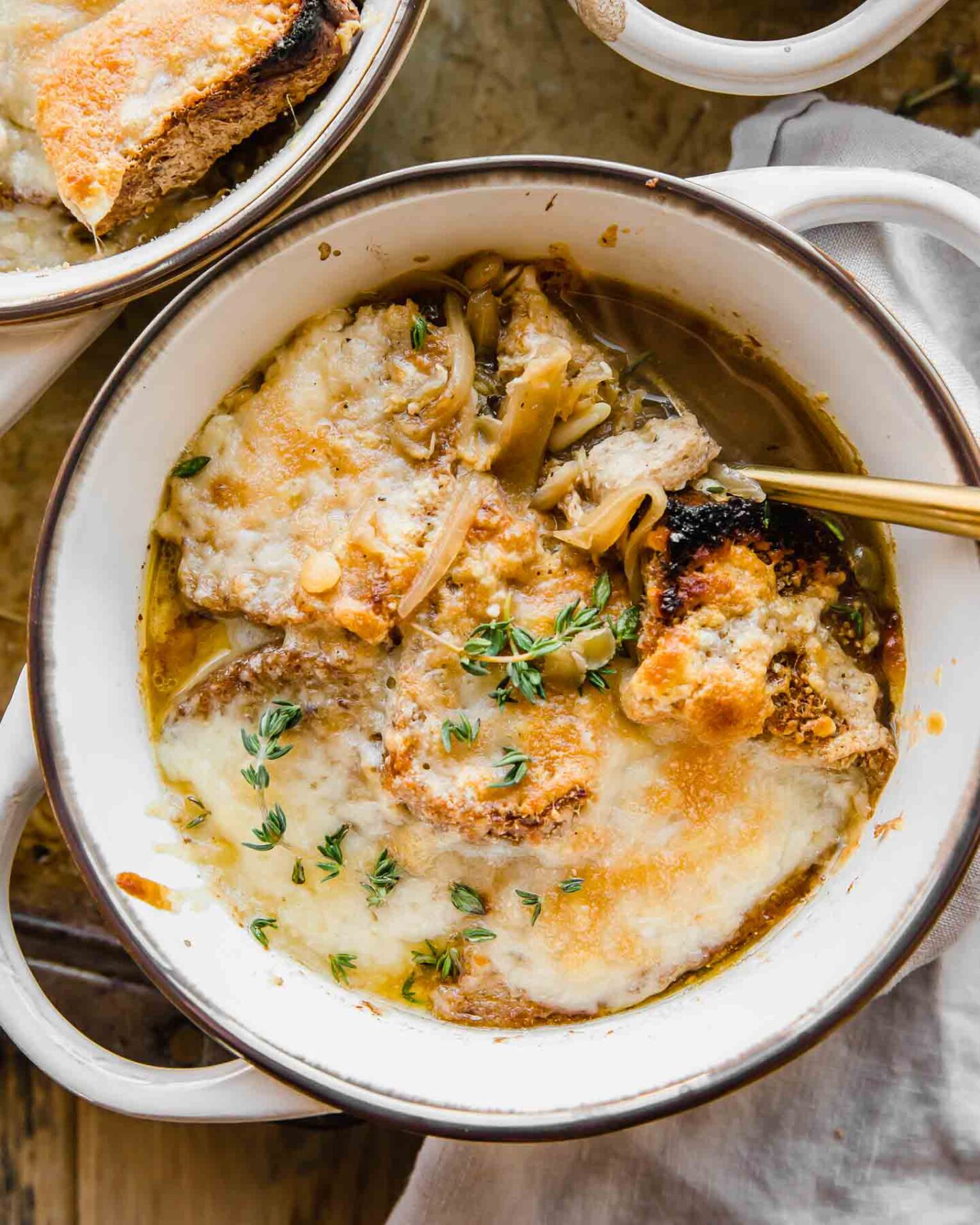 Cozy bowl of Vegetarian French Onion Soup with bread and cheese on top.