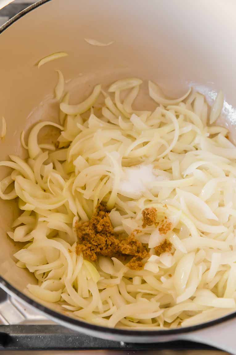 Onions being sautéed and caramelized in a dutch oven.