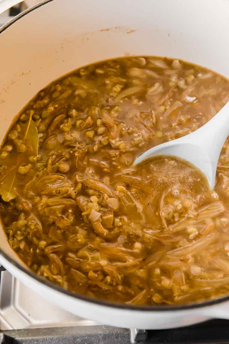 Vegetarian French Onion Soup being cooked in a dutch oven.
