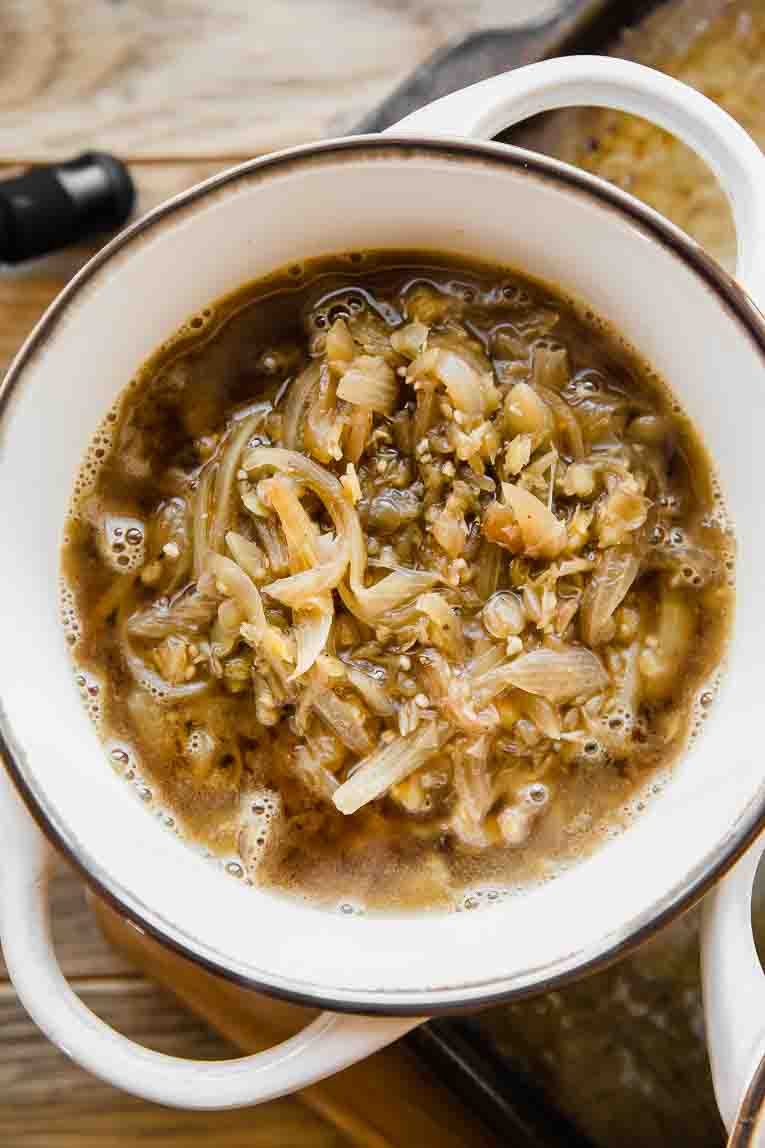 Vegetarian French Onion Soup in a bowl with handles.