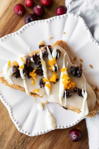 Top photo of Gluten-Free Cranberry Bliss Bar with white chocolate drizzle.