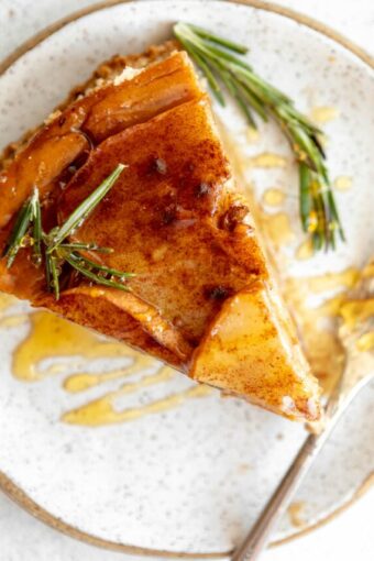 Slice of Honey Pear Ginger Cheesecake on a plate.