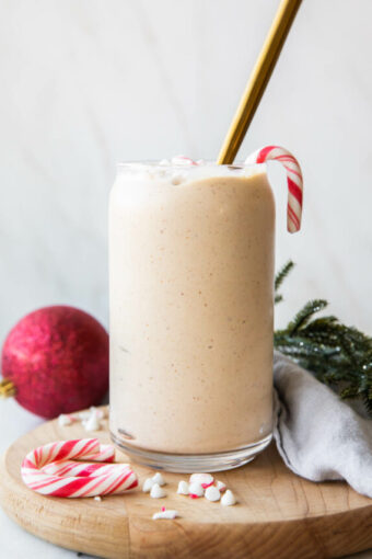Peppermint Frosty Recipe in a glass with candy canes.