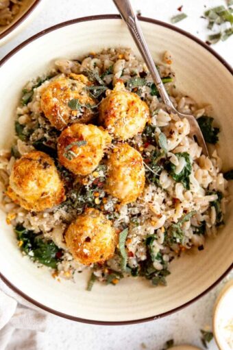 Turkey Sage Meatballs in a dutch oven with parmesan kale orzo.