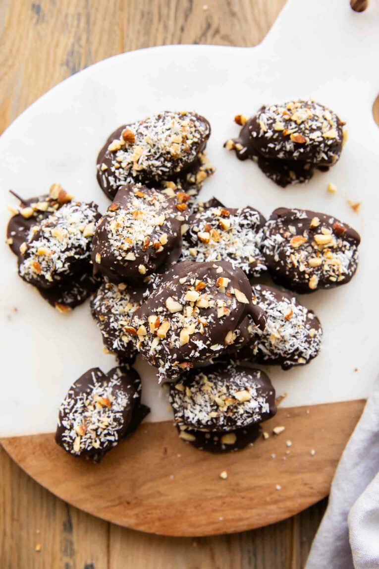 Almond Joy Chocolate Covered Dates on a cutting board.