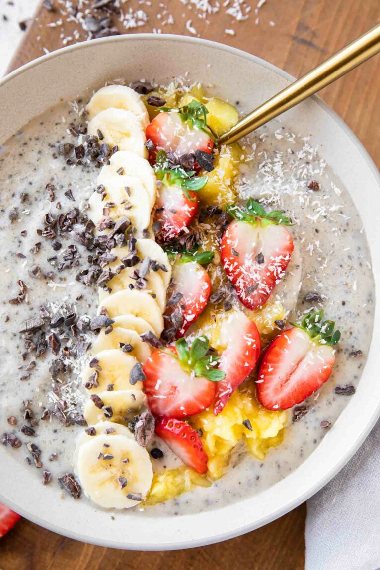 Banana Split Smoothie Bowl with toppings and a large spoon.
