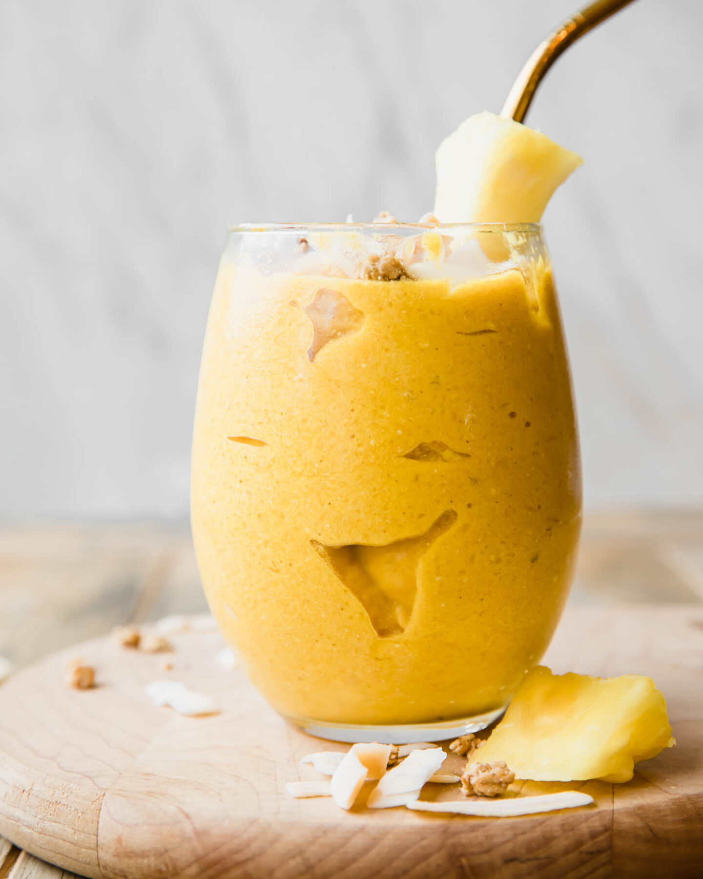 Golden Glow Pineapple Turmeric Smoothie recipe on a wooden table.