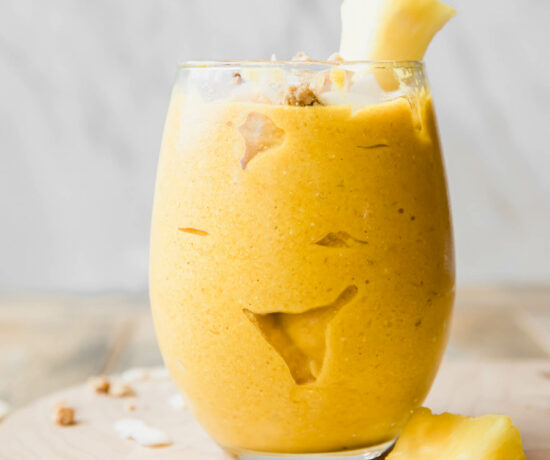 Golden Glow Pineapple Turmeric Smoothie recipe on a wooden table.