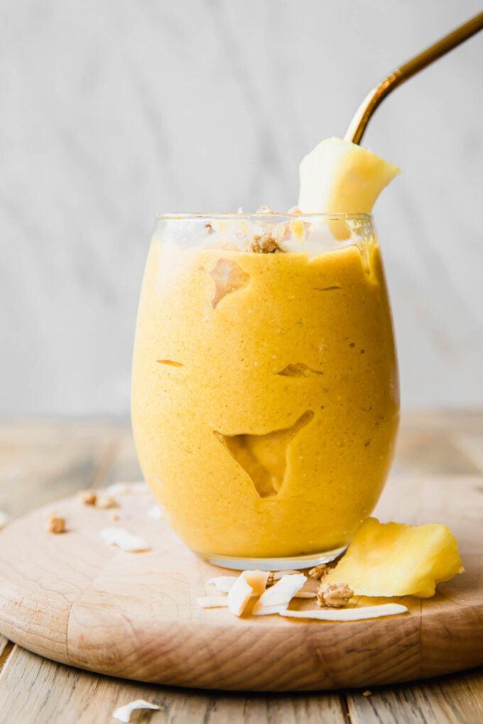 Golden Glow Pineapple Turmeric Smoothie recipe on a wooden table.