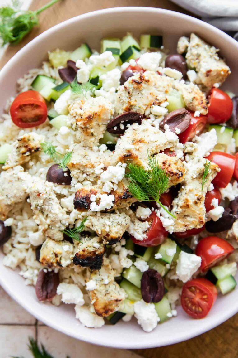 Close up of Greek Chicken Rice Bowls ingredients in a bowl.