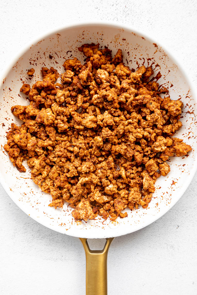 Ground turkey with taco seasoning in a skillet.