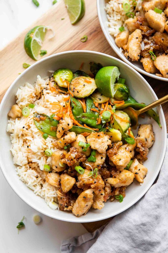 Healthy Honey Sesame Chicken in Meal Prep Bowls.