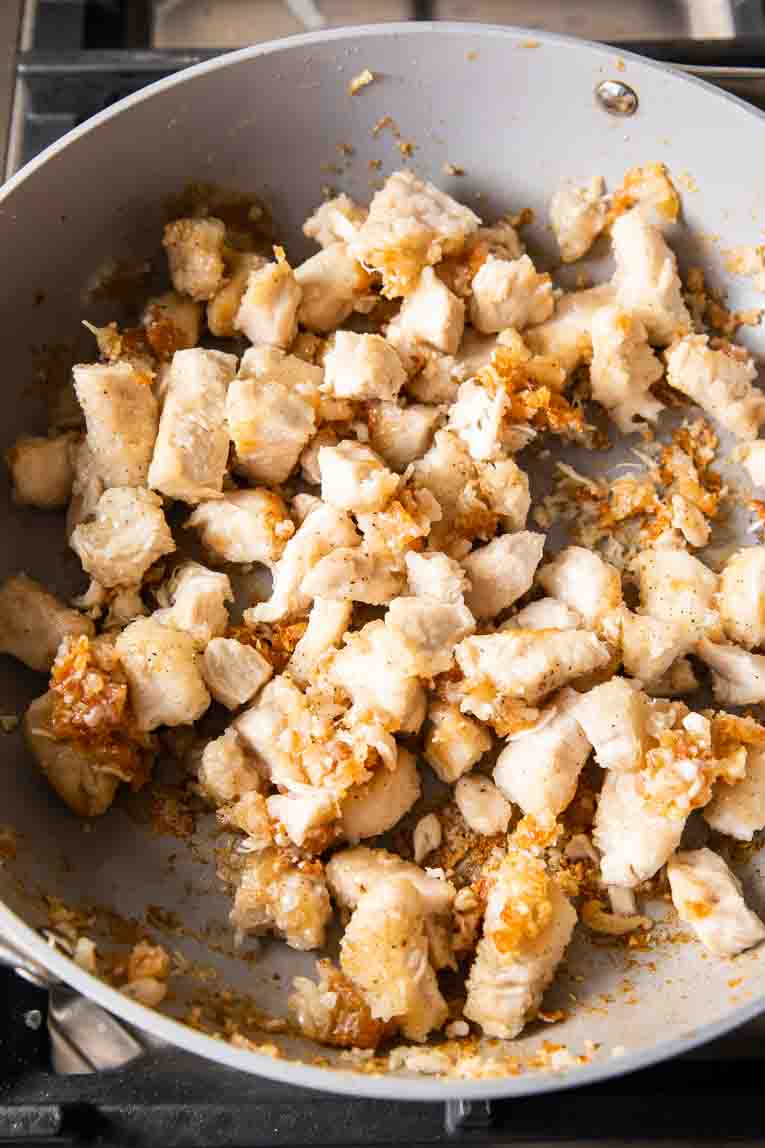 Lightly fried crispy chicken in pan.