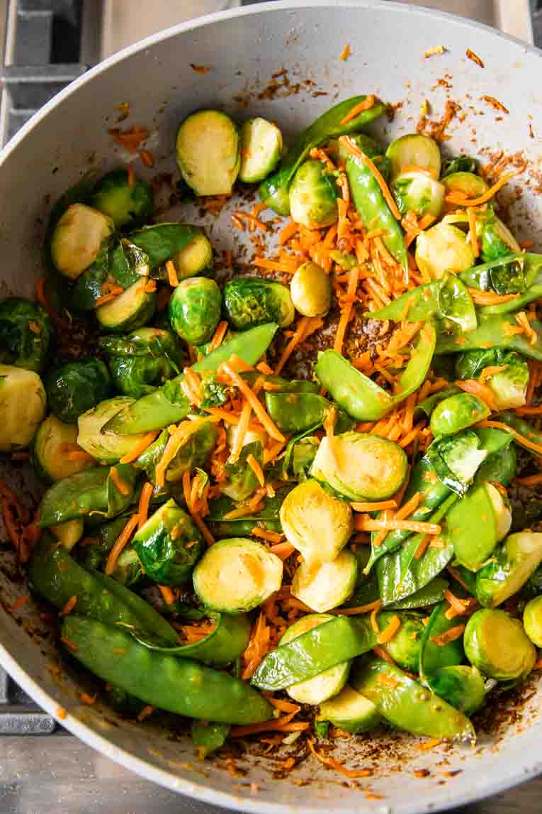 Veggies being sautéed in a non-stick pan.