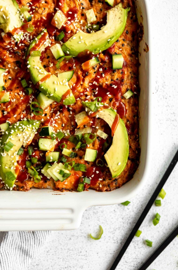 Salmon Sushi Bake Recipe topped with green onions, avocado, and more toppings.