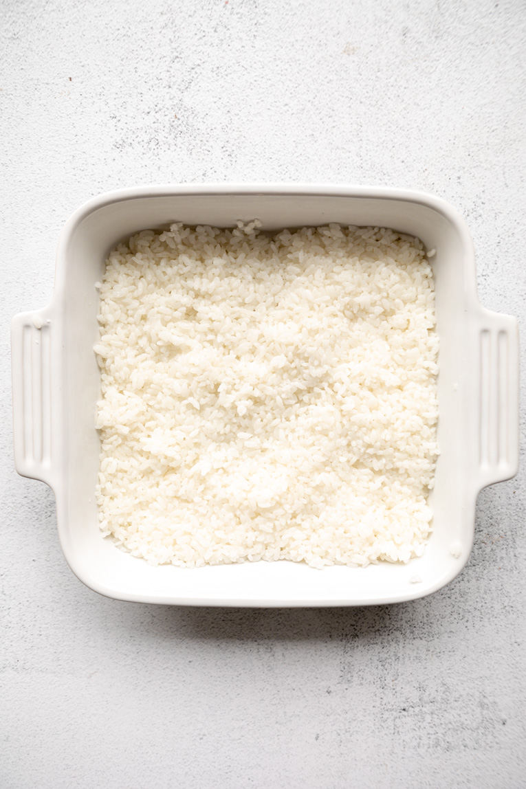 Cooked sticky rice pressed into a baking dish.