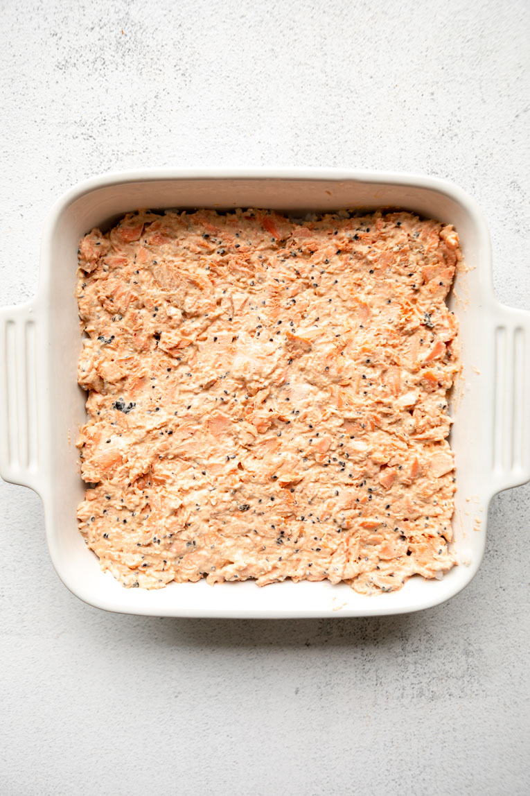 Sushi salmon pressed over rice in a baking dish.