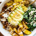 Vegan Turmeric Quinoa Power Bowl with avocado and dressing.