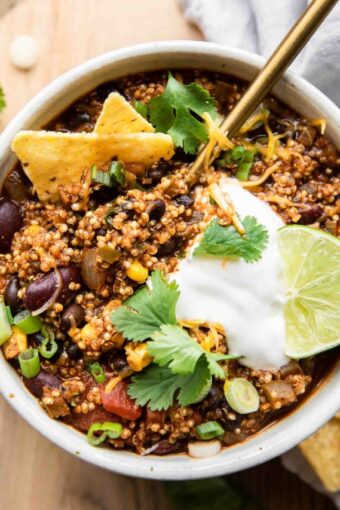 Spoon in a bowl of quinoa chili.