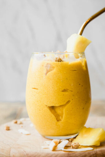 Golden Glow Pineapple Turmeric Smoothie recipe on a wooden table.
