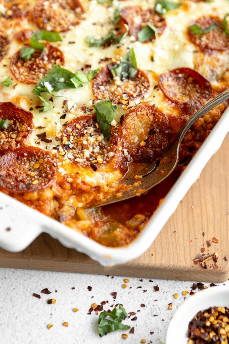 Low-Carb Cauliflower Pizza Casserole with spoonful taken out.