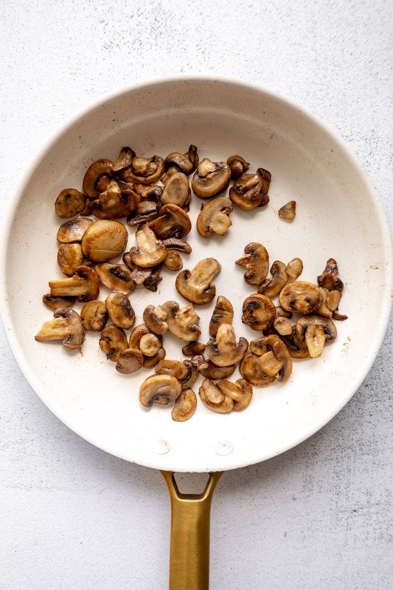 Mushrooms sautéed in a skillet.