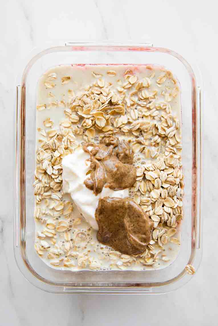 Ingredients for strawberry overnight oats in a container.