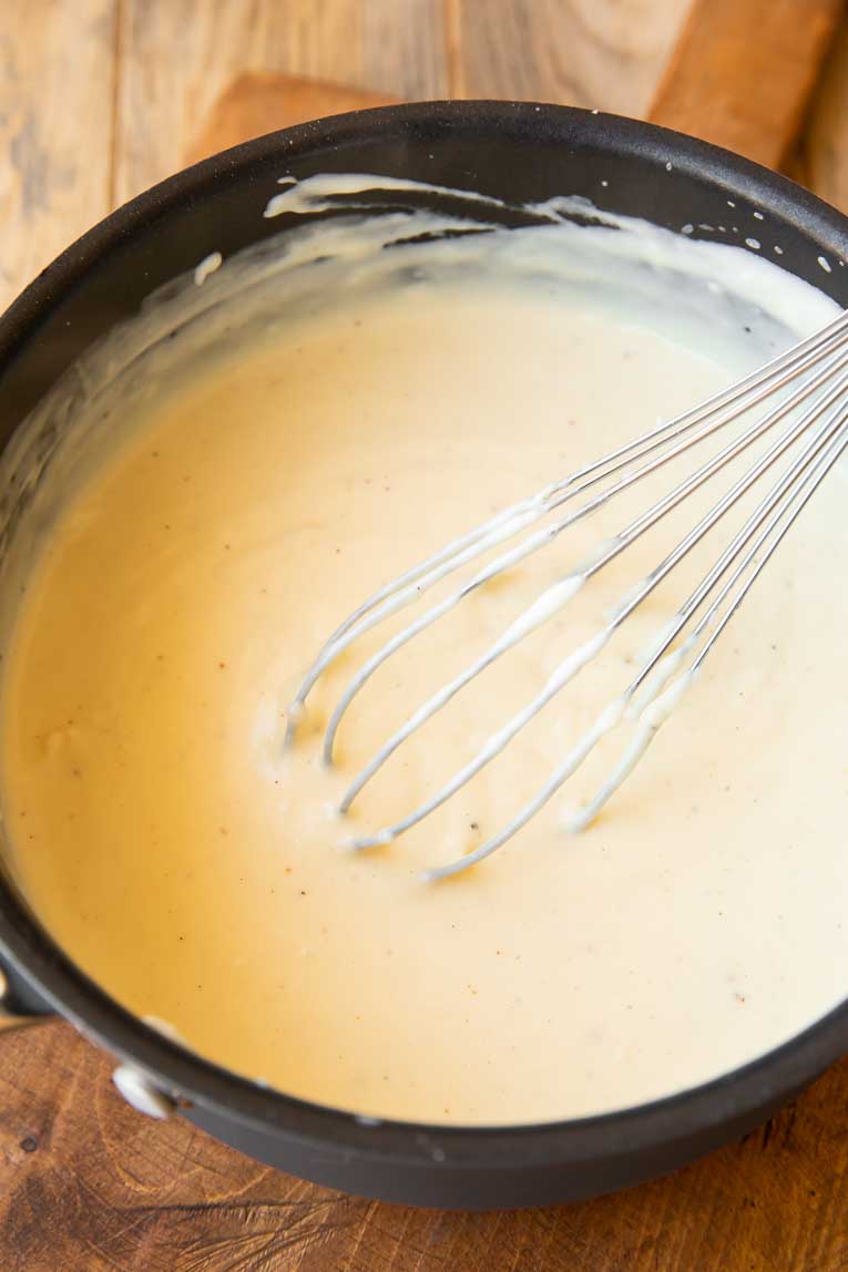 Bechamel sauce being whisked together.