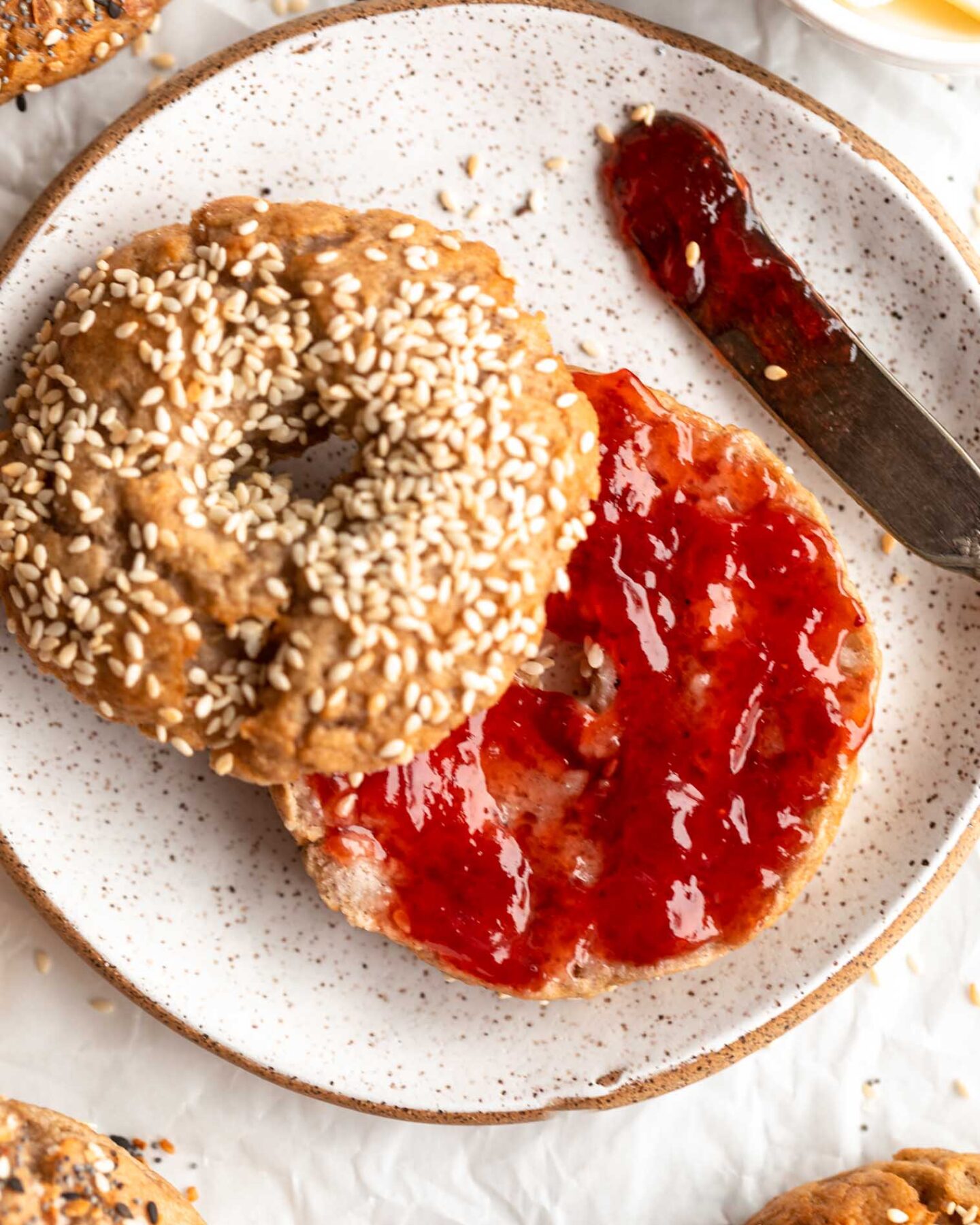 Homemade Gluten-Free Bagel sliced in half and topped with jam.