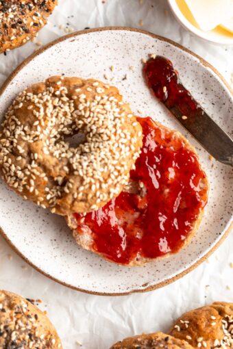 Homemade Gluten-Free Bagel sliced in half and topped with jam.
