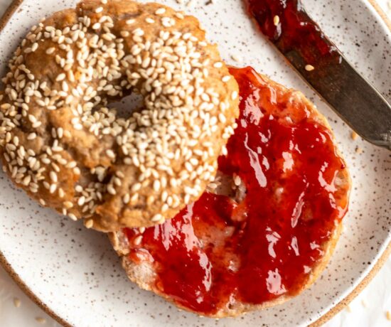 Homemade Gluten-Free Bagel sliced in half and topped with jam.