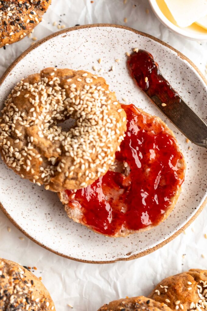 Homemade Gluten-Free Bagel sliced in half and topped with jam.