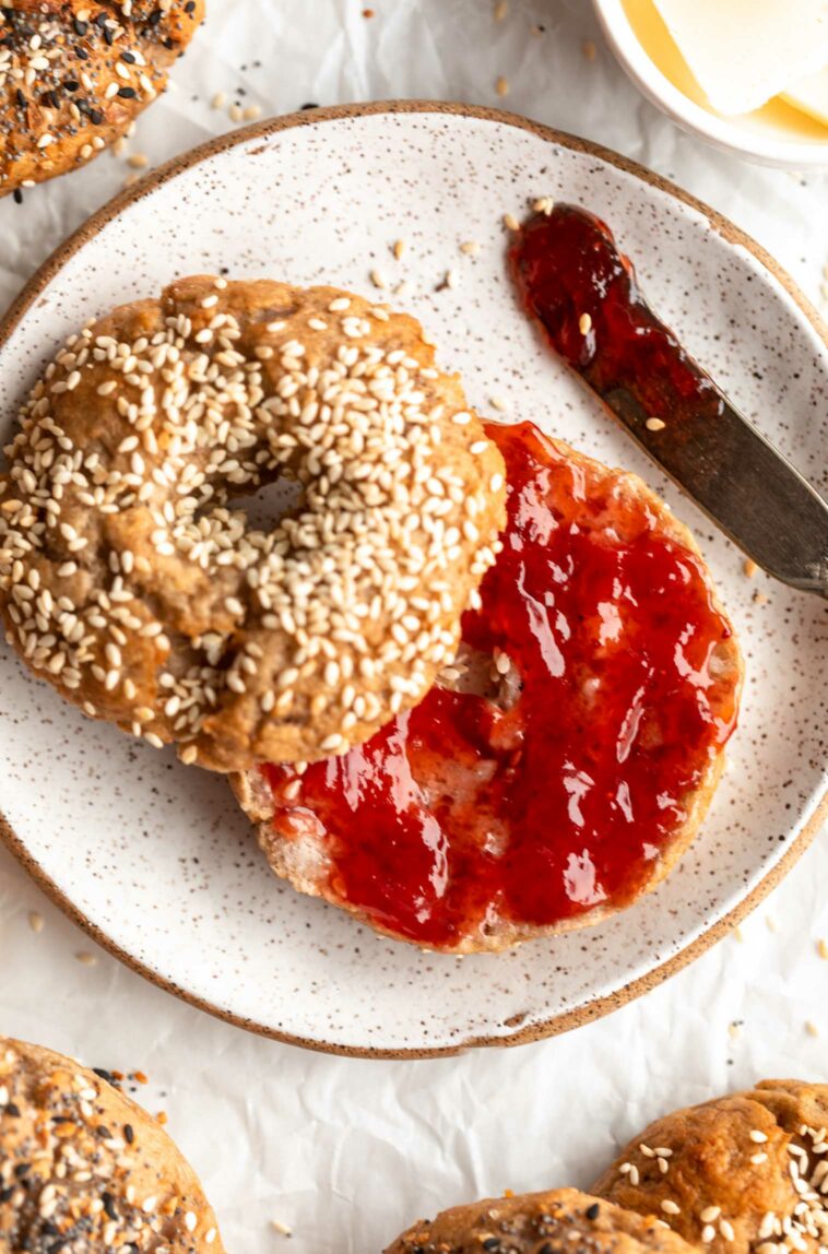 Homemade Gluten-Free Bagel sliced in half and topped with jam.