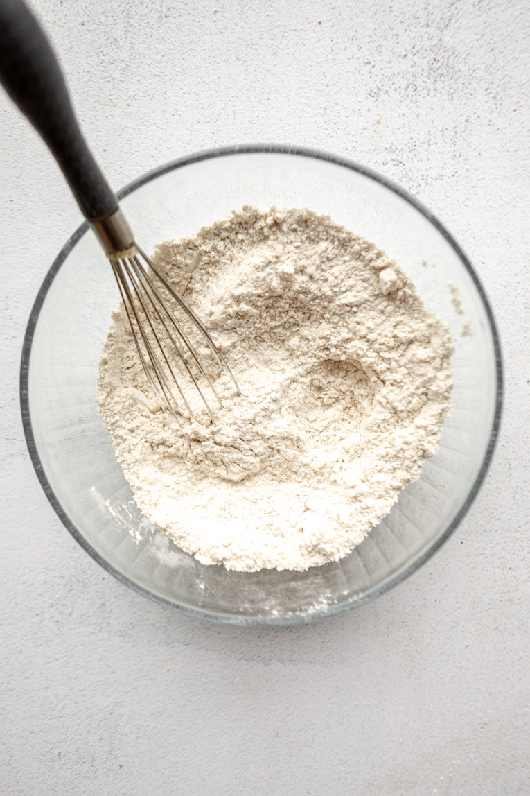 Dry ingredients for gluten-free bagels in a mixing bowl.