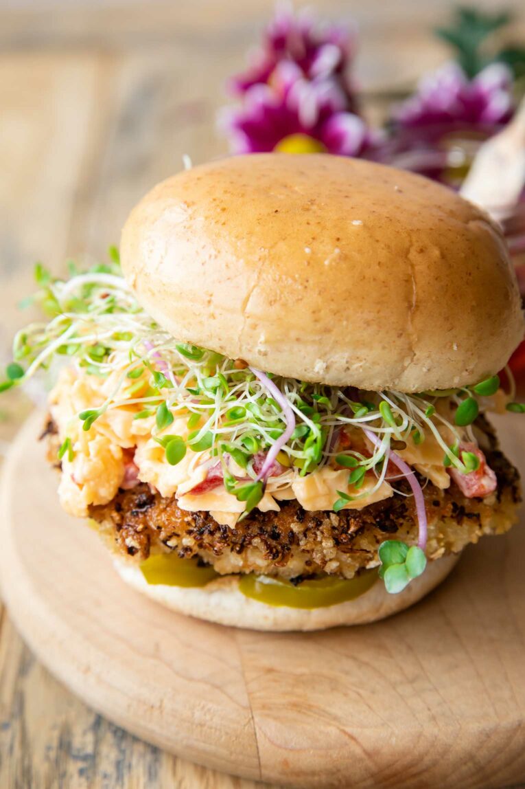 Angled photo of Honey Pepper Pimento Chicken Sandwich.