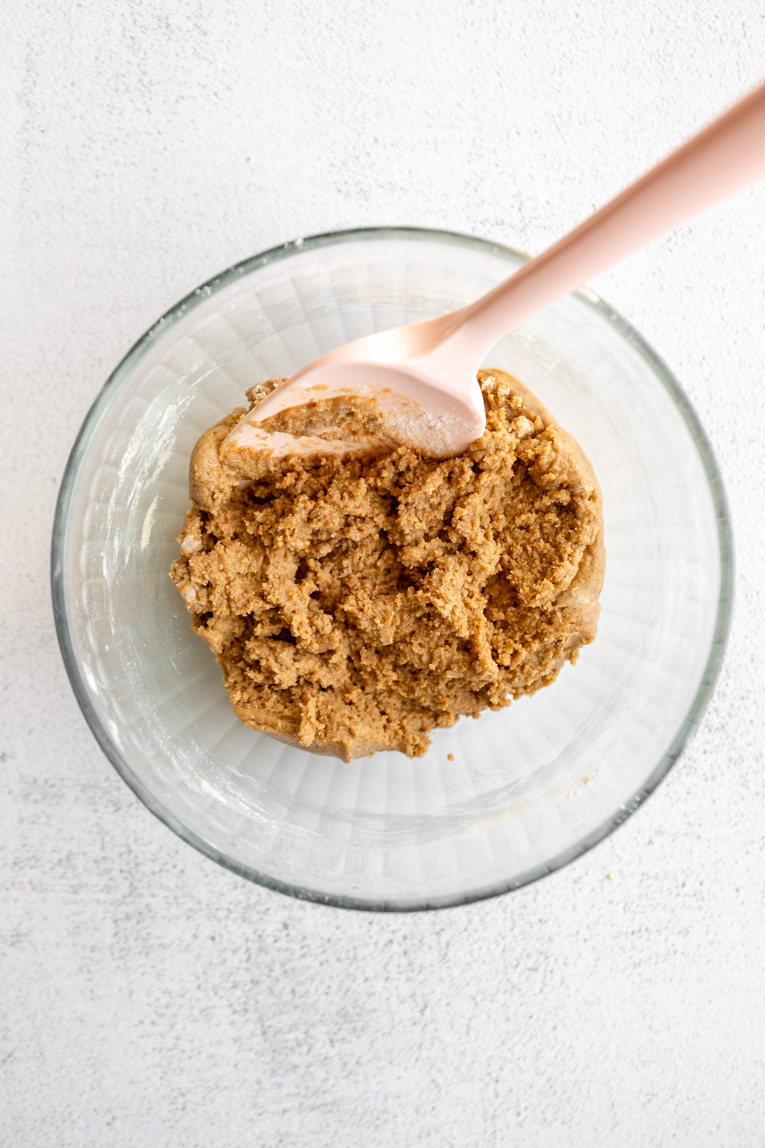 Graham crackers and coconut oil being mixed together.