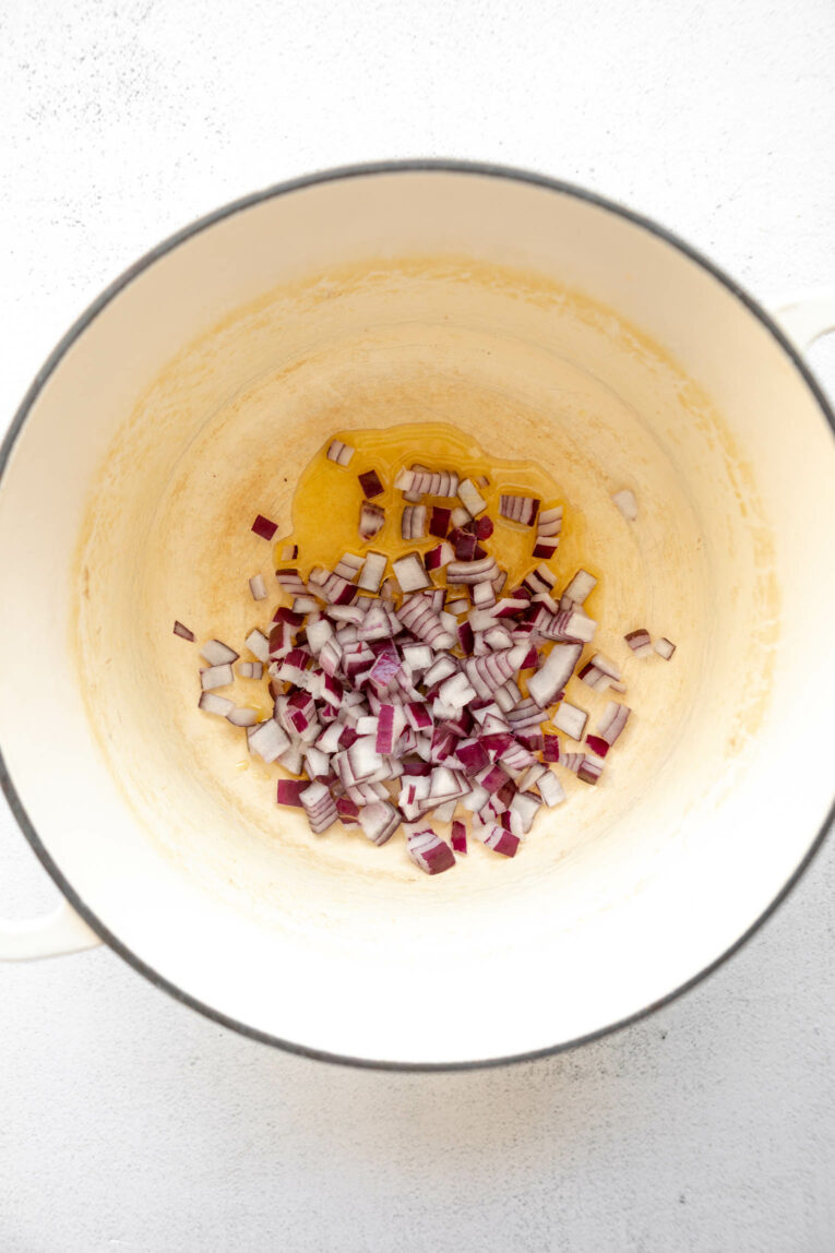 Onion and garlic being cooked in oil.
