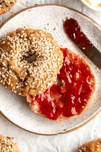 Homemade Gluten-Free Bagel sliced in half and topped with jam.