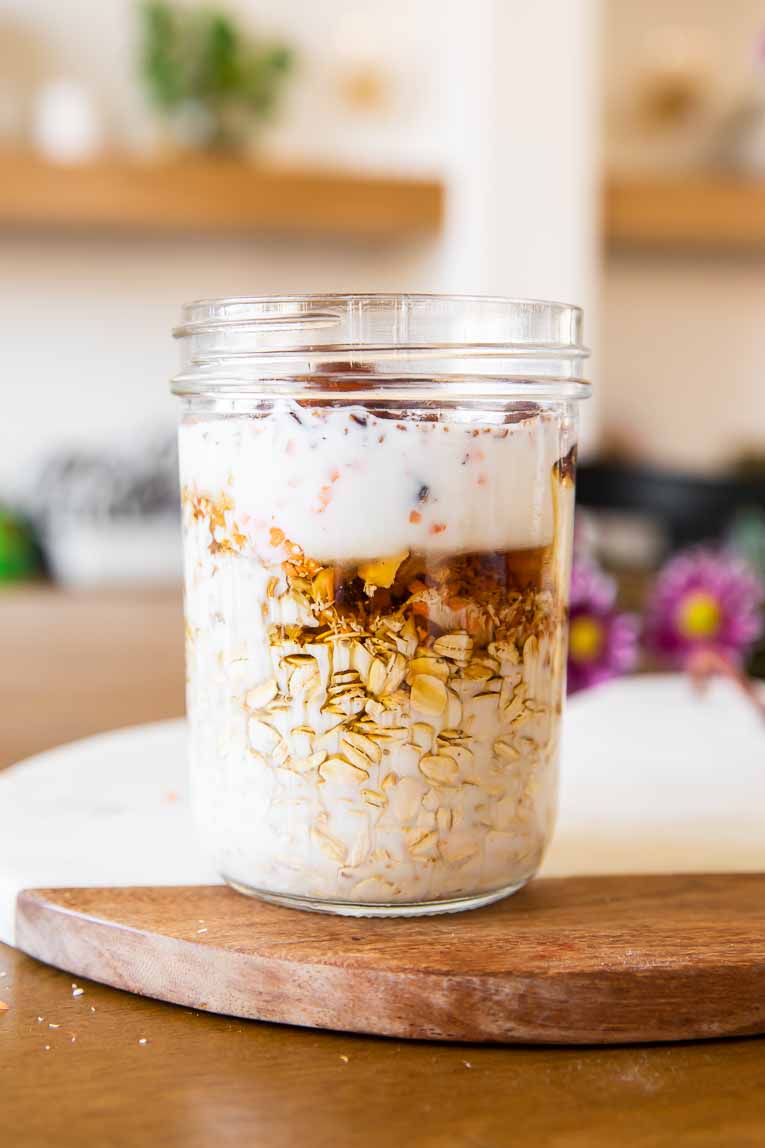Ingredients for Carrot Cake Overnight Oats mixed in a mason jar.