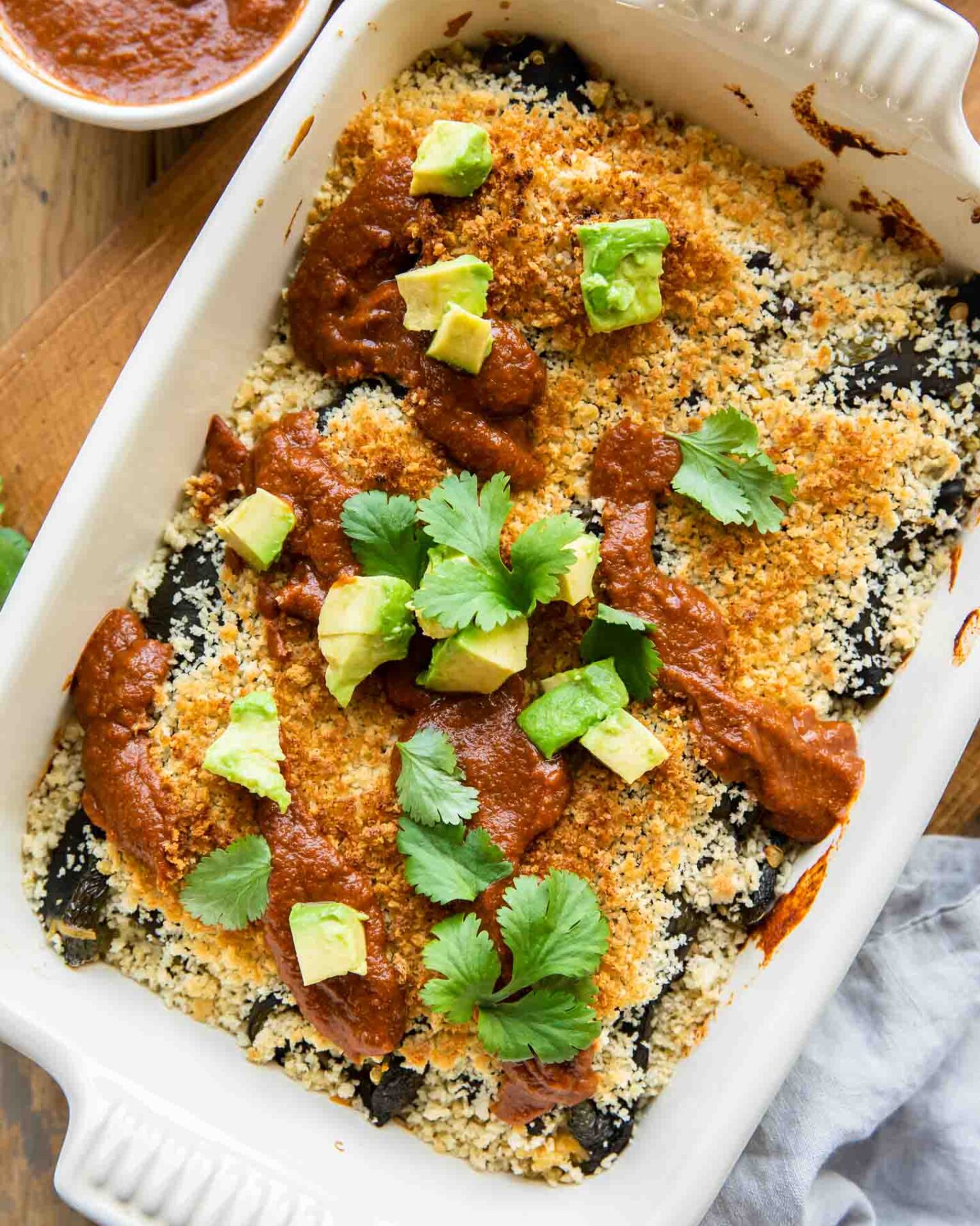 Chile Relleno Casserole with sauce and avocado.
