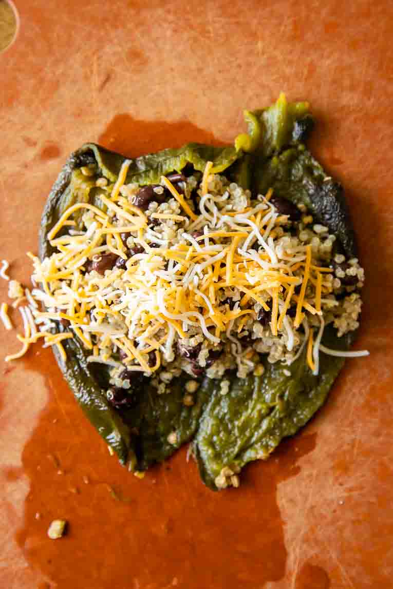 Quinoa, beans, and cheese filling roasted poblano pepper.