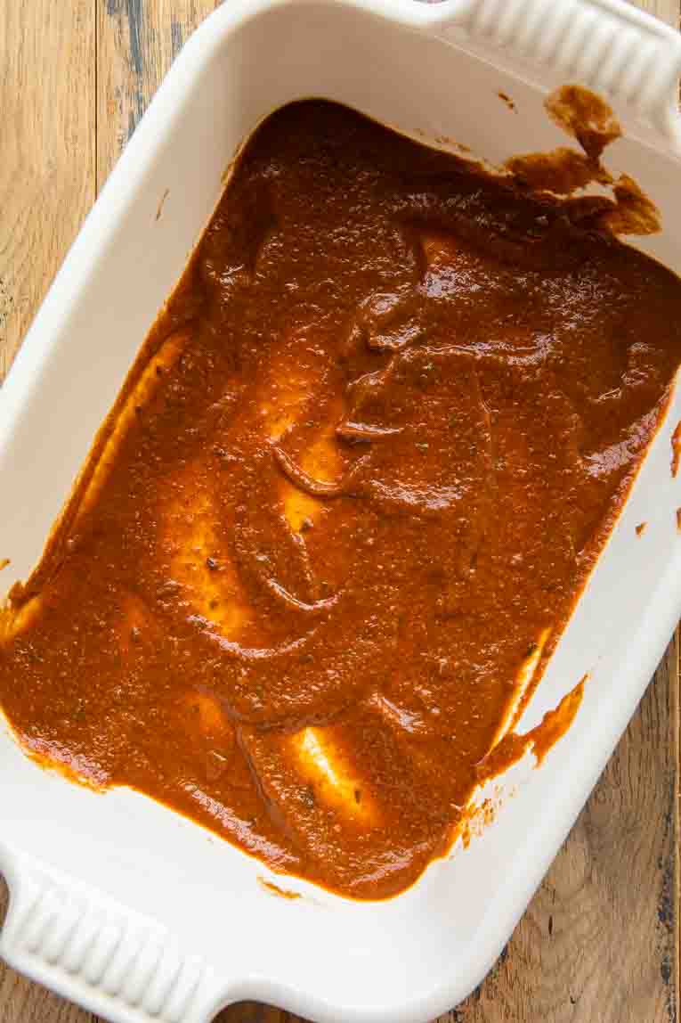Tomato sauce on the bottom of casserole dish.
