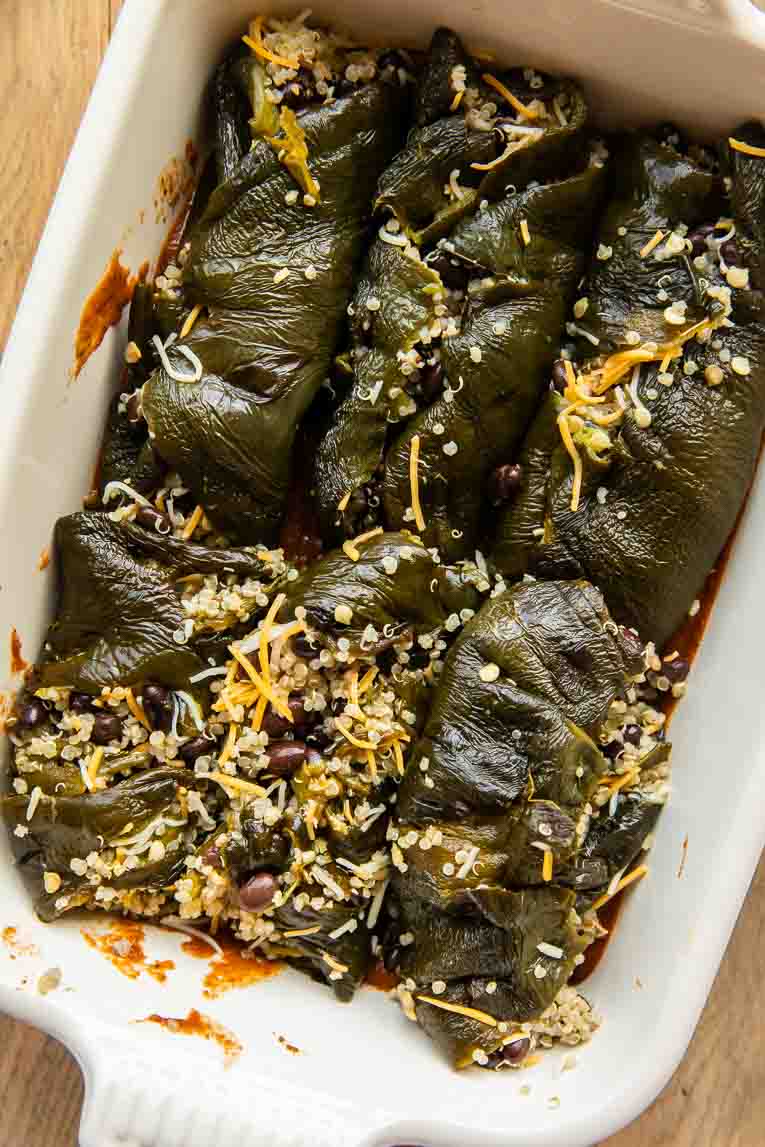 Stuffed chile relleno peppers in a casserole dish.