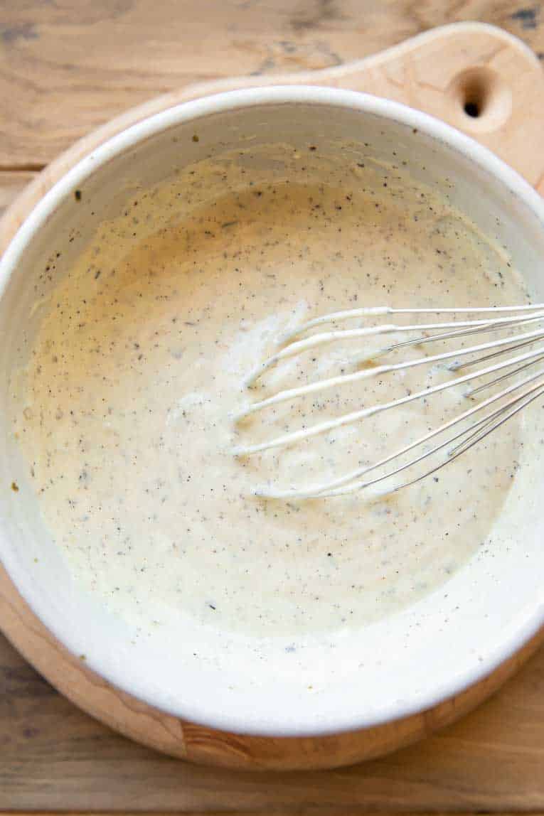 Creamy vegan mayo sauce whisked in a bowl.