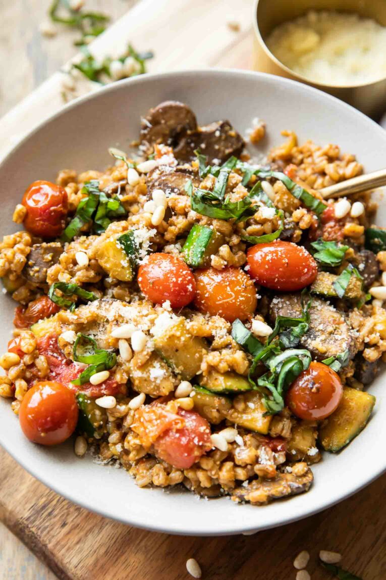 Angled photo of vegetarian Farro with Blistered Tomatoes & Pesto.